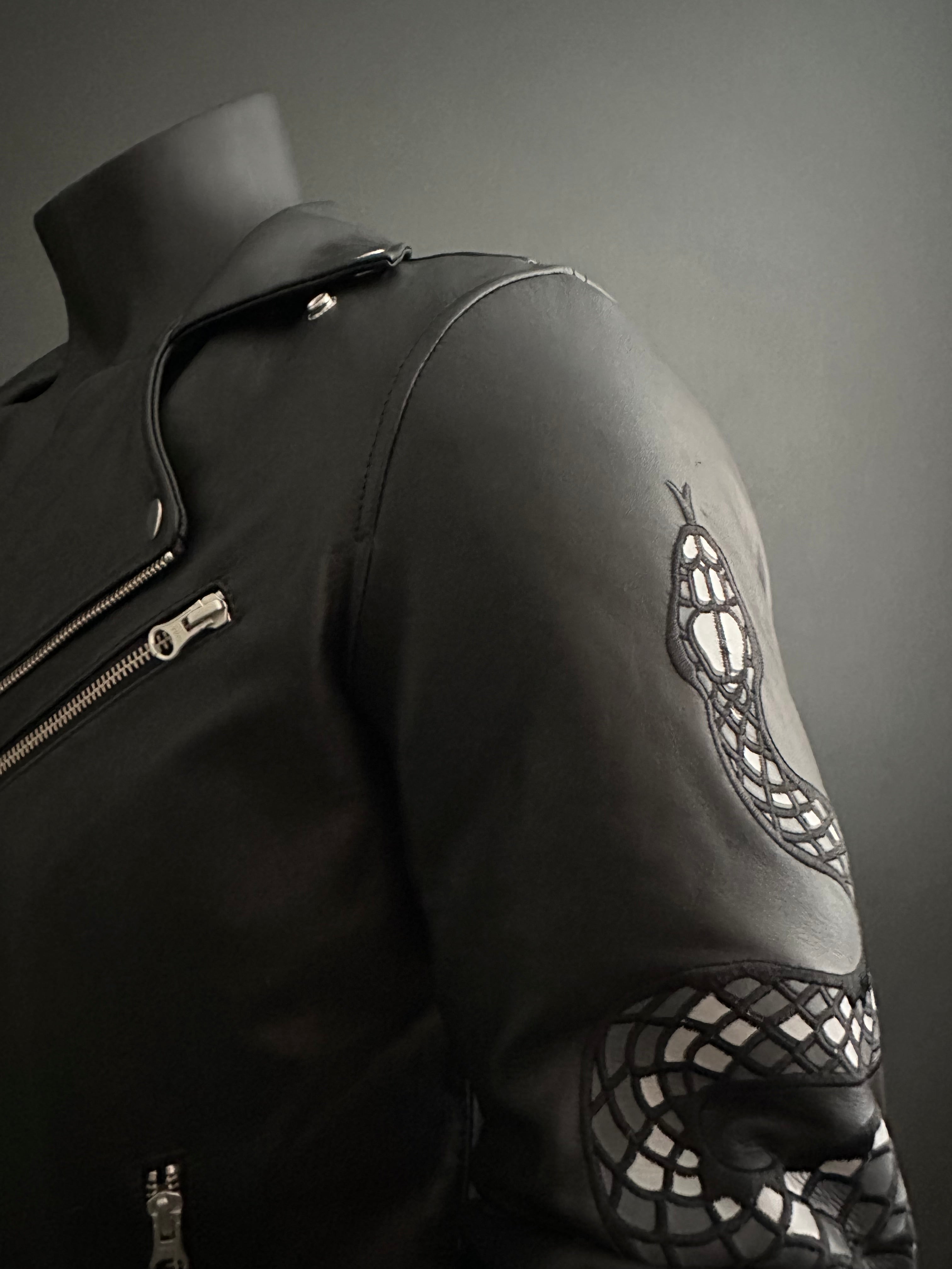 View of black motorcycle jacket lapel and shoulder with custom snake embroidery